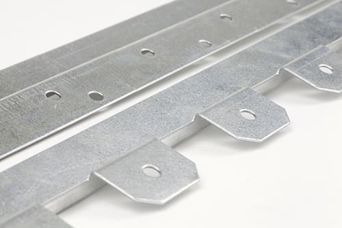 Close-up image of two metal straps. One strap has evenly spaced round holes, while the other has rectangular tabs with holes in the center. Both are made of silver-colored metal and are positioned diagonally across a plain white background.