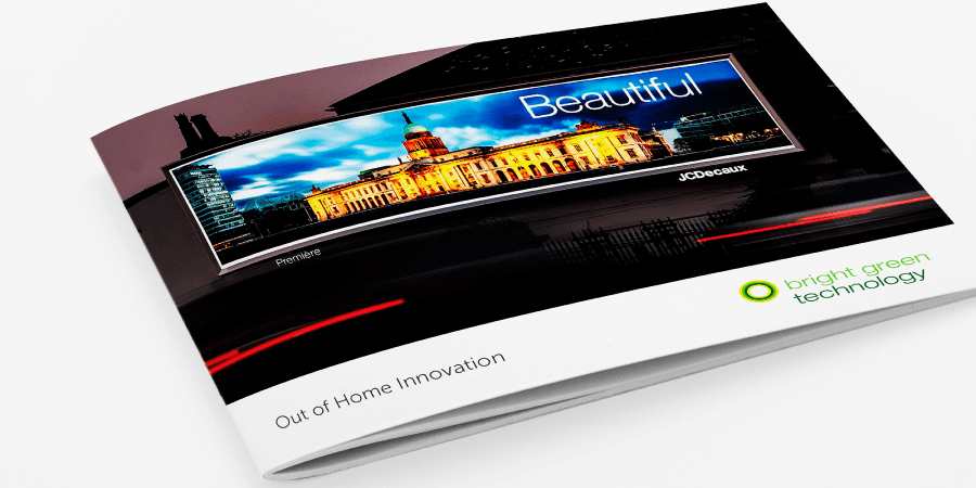 A folded brochure displays an advertisement for "bright green technology" with the tagline "Out of Home Innovation." The cover features a cityscape with a lit-up building and the word "Beautiful" on a large electronic billboard.