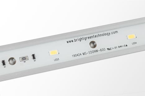 Close-up image of a bright green technology LED light strip. The strip includes various small components and has the website "www.brightgreentechnology.com" printed on it along with model number 190424 MS-5050NW-600 and other technical specifications.