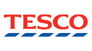 The image shows the Tesco logo. It features the word "TESCO" in bold red capital letters, with a blue wavy line underlining the letters. The background of the image is transparent.