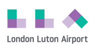 A logo with three geometric shapes in green and purple, followed by the text "London Luton Airport". The shapes are two squares, each divided into four smaller squares (two green and two purple), and a diamond divided similarly.