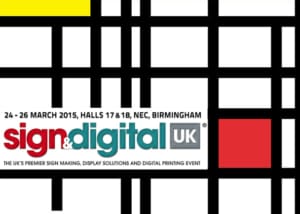 Event poster for Sign & Digital UK 2015. It features intersecting black lines with a yellow square in the top left corner, a red square in the bottom right, and details of the event held from March 24-26, 2015 at NEC, Birmingham. Text reads "Sign & Digital UK".