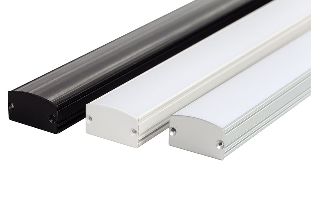 Three elongated LED light fixtures laid side by side. They have rectangular shapes with slightly arched tops and come in three different finishes: black, metallic, and white. Each fixture has a sleek and modern design with mounting holes on both ends.