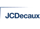 The image features the JCDecaux logo, which consists of the name "JCDecaux" written in blue capital letters with a stylized vertical and horizontal line forming an "L" shape on the top left corner of the text.