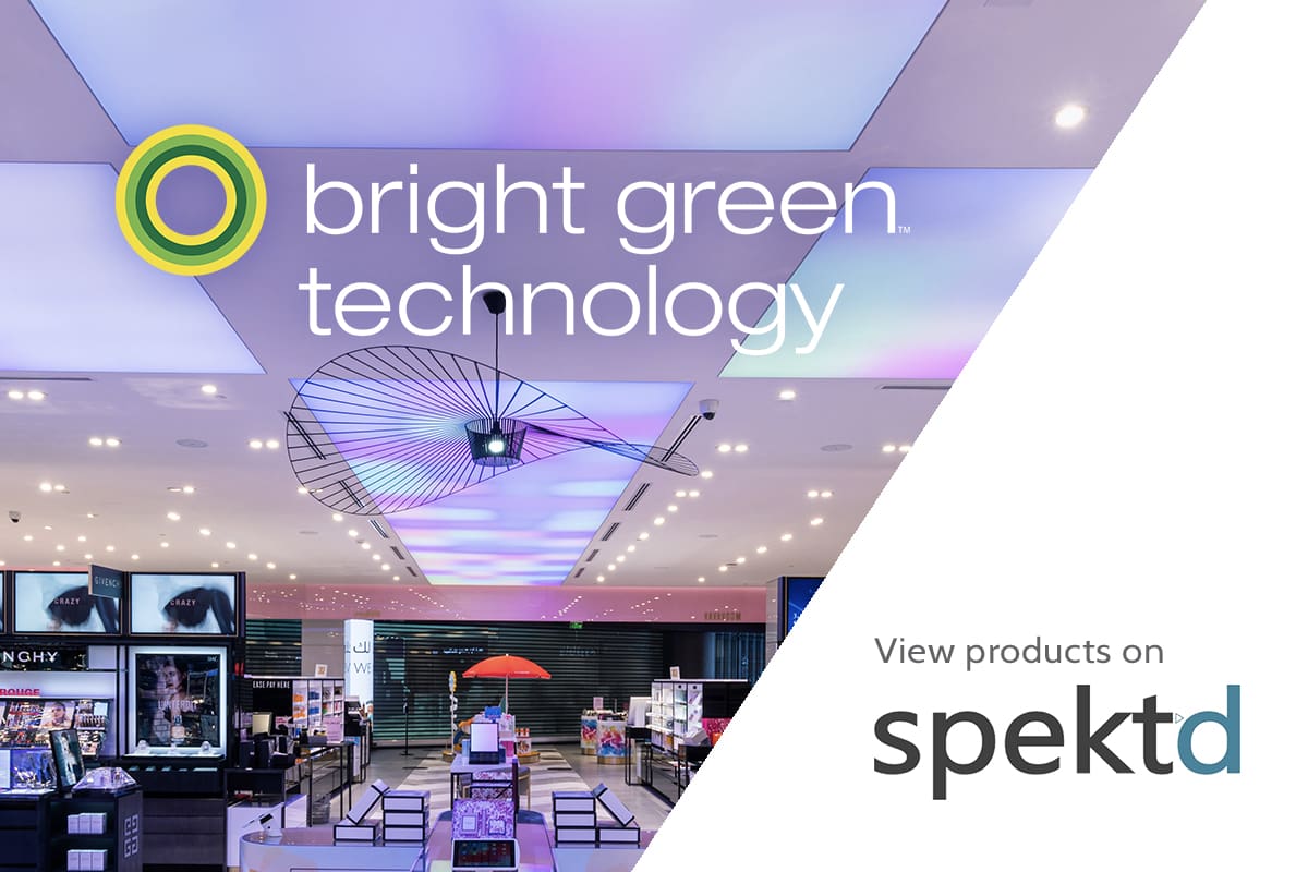 A brightly lit modern store interior. The text on the image reads "bright green technology" with a green and yellow circular logo and "View products on spektd". The background features various products and displays under colorful lighting.