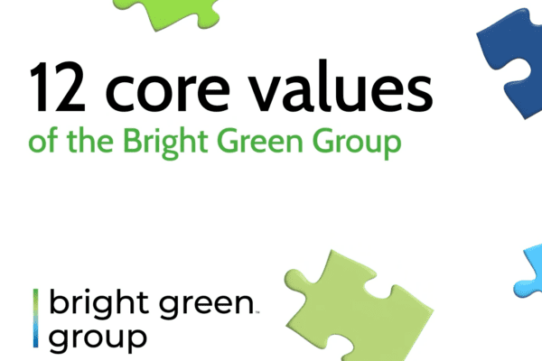 The image features the text "Bright Green Group 12 Core Values" at the center. Below, the Bright Green Group logo is displayed, consisting of the words "bright green group" next to a green and blue vertical line design. Colorful puzzle pieces are arranged around the edges.