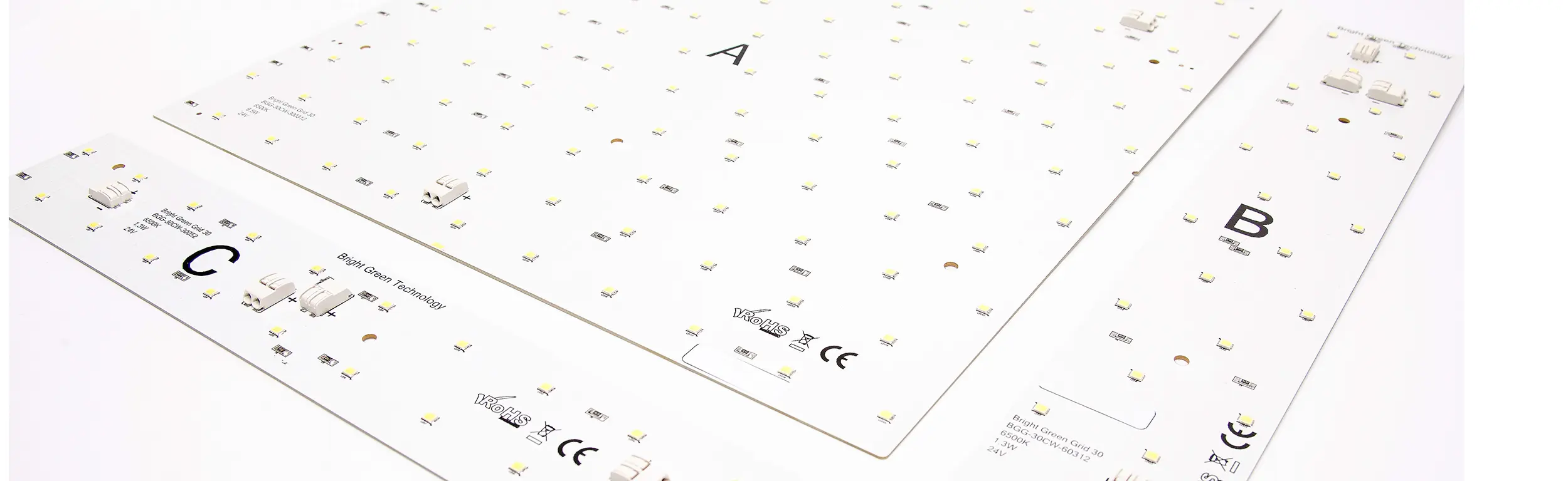 Close-up image of three white LED boards labeled as A, B, and C. The boards feature numerous small LED lights and some electronic components. Various certification marks and technical details are printed on the boards' surfaces.